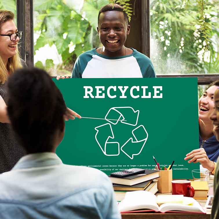 Student holding Recycling sign